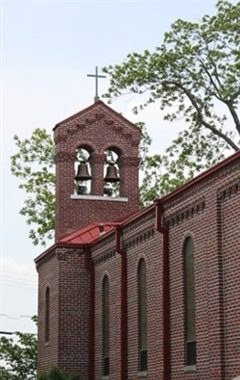 A church with a bell tower and red roof.