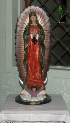 A statue of the virgin mary with blood on it.