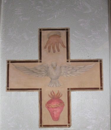 A cross with a dove and hands on it.