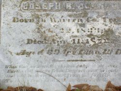 A close up of the headstone with an old photo
