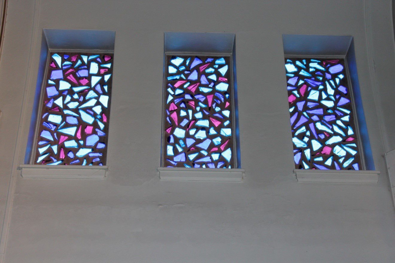 Three windows with a mosaic design on them.