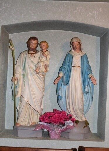 A statue of jesus, mary and joseph in a box.